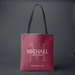 Burgundy Red Personalized Groomsmen Tote Bag<br><div class="desc">Add a personal touch to your wedding with personalized groomsmen tote bag. This bag features personalized groomsman's name with title and wedding date in white and monogram in light burgundy red as background, in classic serif font style, on burgundy red background. Also perfect for best man, father of the bride,...</div>