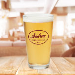Burgundy Stylized Wedding Groomsman Name Glass<br><div class="desc">Beer glass for the wedding groomsman that features his name printed in a trendy burgundy, stylized script inside a burgundy colour oval border along with wedding date. A great party supply idea for a bachelor party! Personalize your beer glass by editing and replacing name and date with your own. Available...</div>