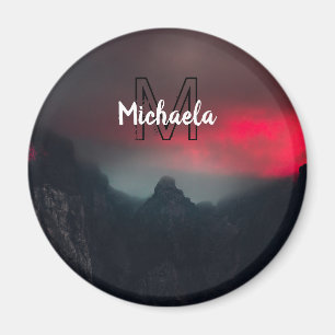 Burning clouds, fog and mountains monogram in sky magnet