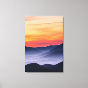 Burning sunset and fog in valley canvas print