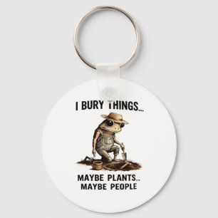 Bury things maybe plants maybe people funny frog keychain