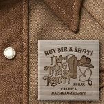 Buy Me a Shot Cowboy Bachelor Party Groom's 2 Inch Square Button<br><div class="desc">Celebrate the groom to be with this cute bachelor party button. Features a fun cowboy western design that reads: Buy me a shot, I'm tying the knot! The artwork boasts vintage woodcut lettering with a cowboy boot, hat, and lasso rope forming a heart shape. There is room for his name...</div>