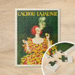 Cachou Lajaunie | Leonetto Cappiello Jigsaw Puzzle<br><div class="desc">Cachou Lajaunie (1920) | Leonetto Cappiello’s 1920 advertising poster for Cachou Lajaunie showcases a striking image of a red-haired woman dressed in a bold red and yellow gown, elegantly smoking against a rich dark green background. The vibrant colours and dynamic pose of the woman immediately capture attention, reflecting Cappiello’s signature...</div>