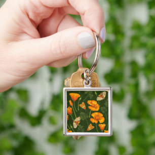 California poppies and moths on dark green keychain