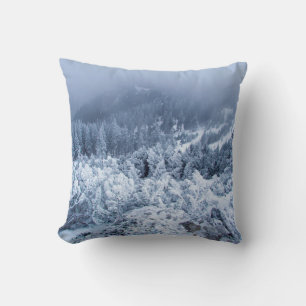Calm foggy winter day on top of the mountains throw pillow