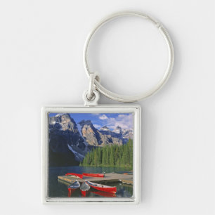 Canada, Alberta, Moraine Lake. Red canoes await Keychain