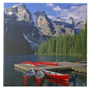 Canada, Alberta, Moraine Lake. Red canoes await Tile