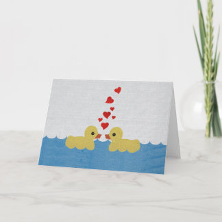 Canards dans la carte de voeux de blanc d'amour
