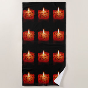 Candle on a black background beach towel