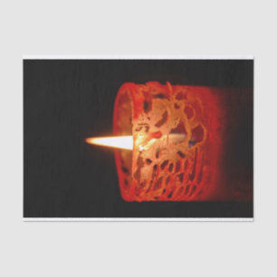 Candle on a black background tissue paper
