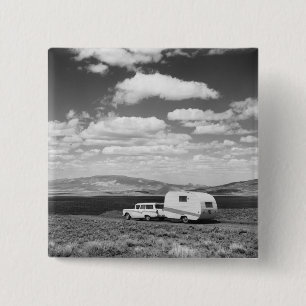 Car pulling trailer on road 2 inch square button