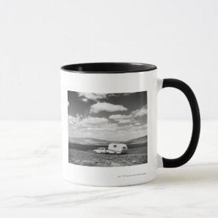 Car pulling trailer on road mug