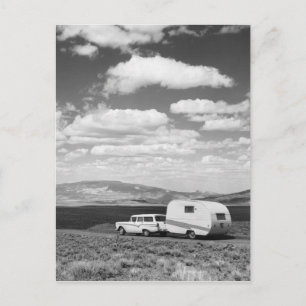 Car pulling trailer on road postcard
