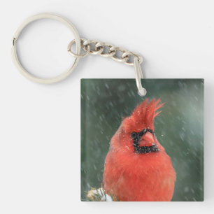 Cardinal in a pine tree during a snow storm keychain