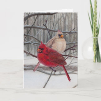 Cardinaux dans la carte de vacances de neige