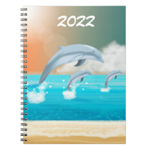 Carnet dauphins faisant des sauts dans l'océan