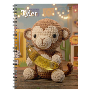 Carnet Mignon singe au crochet tenant une banane au zoo