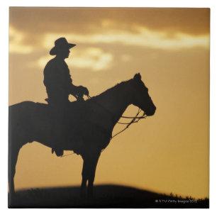 Carreau Silhouette de cowboy à cheval au coucher du soleil