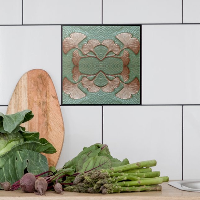 Carreaux Gingko en céramique (Single Green and copper Gingko leaf tile shown with white tiles in a kitchen.)