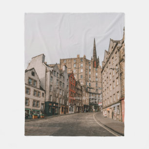 CARS PARKED BESIDE BROWN CONCRETE BUILDING DURING FLEECE BLANKET