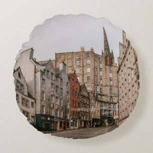 CARS PARKED BESIDE BROWN CONCRETE BUILDING DURING ROUND PILLOW