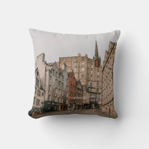 CARS PARKED BESIDE BROWN CONCRETE BUILDING DURING THROW PILLOW