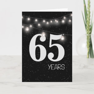 Carte 65e anniversaire avec lumières et étoiles