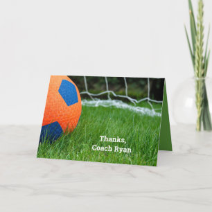Carte Boule de football orange sur gazon
