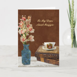 Carte Bouquet d'orchidées avec des livres et une tasse p