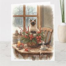 Chat siamois arrangeant des fleurs en hiver Noël