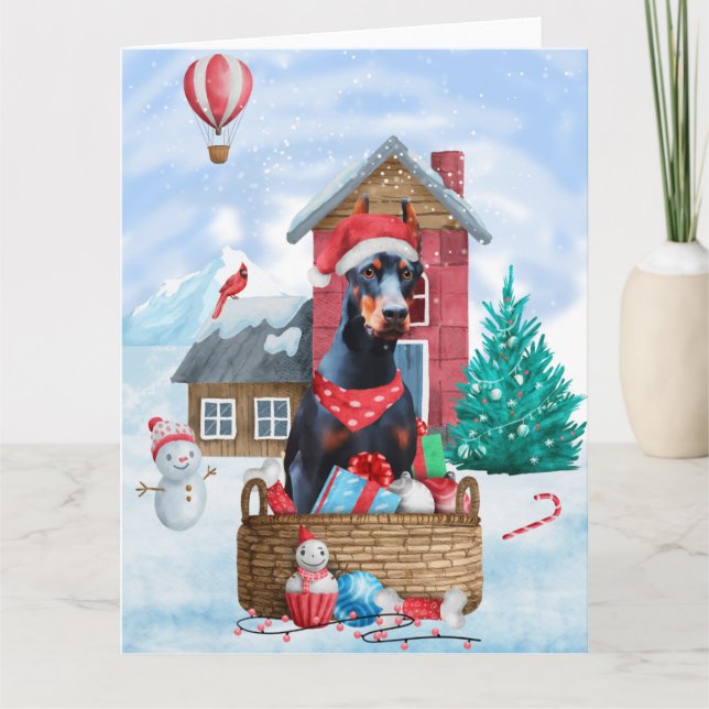 Carte Chien Dobermann dans la maison de Noël enneigée po (Devant)