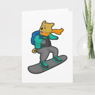 Carte Chien en planchiste avec planche à neige et sac à