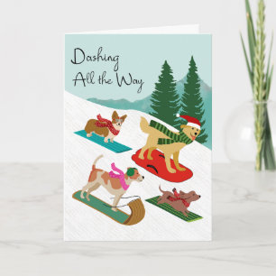 Carte Chiens de Noël faisant de la luge en descendant la