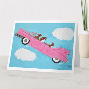 Carte Dachshunds dans une décapotable rose dans le ciel