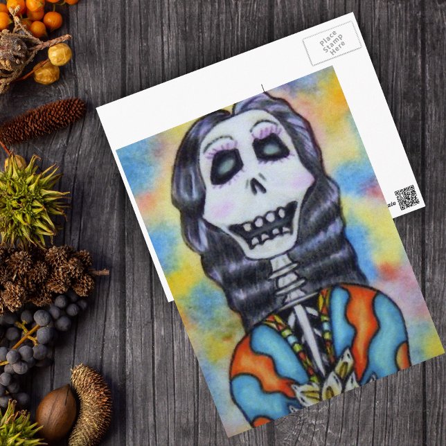 Carte de Jour des Morts (Day of Dead happy lady skeleton orange blue cape flowers on postcard.)