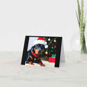 Carte de Noël avec Rottweiler portant le chapeau d