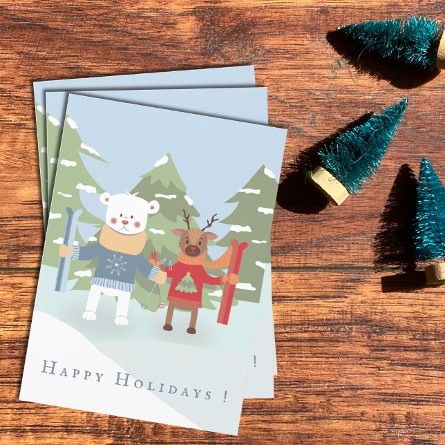 Carte de vacances pour enfants avec ours polaires  (Polar bear and reindeer kid Holiday cards laying flat on a desk .)