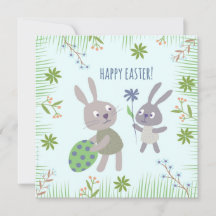 Deux lapins de Pâques avec oeuf et fleur.