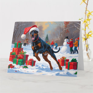 Carte Doberman courant dans la neige avec un chapeau de