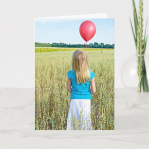 Carte fille dans le champ de blé avec ballon rouge