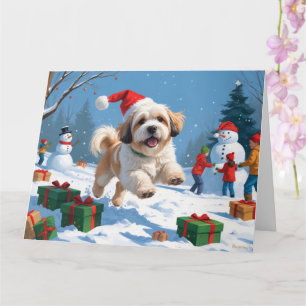 Carte Lhasa Apso courant dans la neige avec un chapeau d