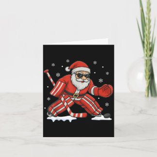 Carte Père Noël jouant au gardien de but de hockey sur g