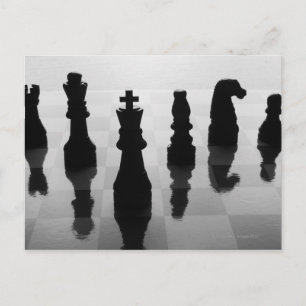 Carte Postale Chess pieces on chess board in black and white