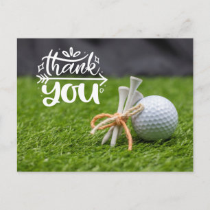 Carte Postale Golf ball et tee are on green grass merci