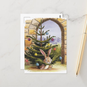 Carte Postale Le mignon lapin de Noël nibble l'arbre