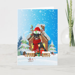 Carte Rottweiler dans la neige avec cadeaux de Noël