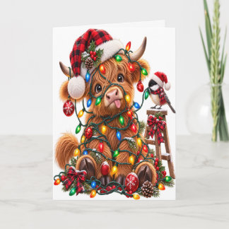 Carte Vache Highland emmêlée dans les lumières de Noël
