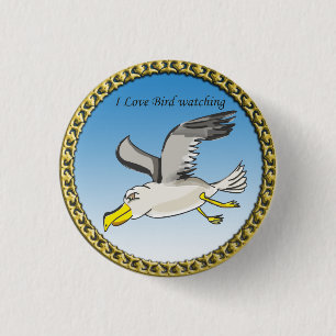 Cartoon seagull flying over head with a gold frame 1 inch round button
