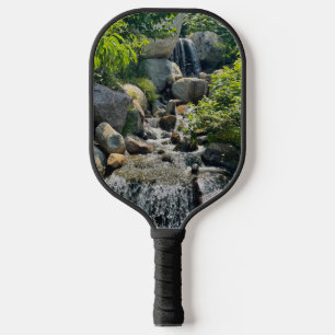 Cascading forest waterfall   forest greenery   pickleball paddle