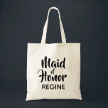 Casual Script Maid of Honour Monogram Favour Tote Bag<br><div class="desc">Trend typography monogram tote bag. Modern and stylish, this custom design features the text "Maid of Honour" in casual script lettering and an editable text field for a name in elegant sans serif in black. Easily personalize this design to match your style by clicking "Customize" to go to the design...</div>